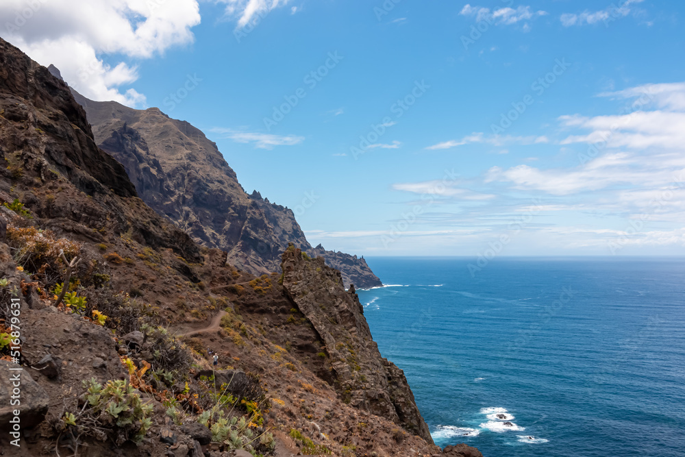 Panoramic view of Atlantic Ocean coastline and Anaga mountain range on Tenerife, Canary Islands, Spain, Europe, EU. Looking at Cabezo el Tablero crag. Scenic coastal hiking trail from Afur to Taganana