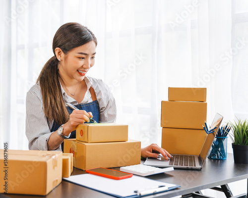 Entrepreneurs Small Business SME, Young Asian women happy after a new order from the customer, business owner working at home office.