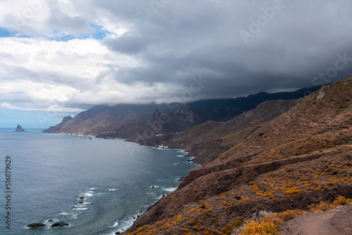 Scenic view of Atlantic Ocean coastline and Anaga mountain range on Tenerife, Canary Islands, Spain, Europe. Looking at Roque de las Animas crag and Roque en Medio. Hiking trail from Afur to Taganana