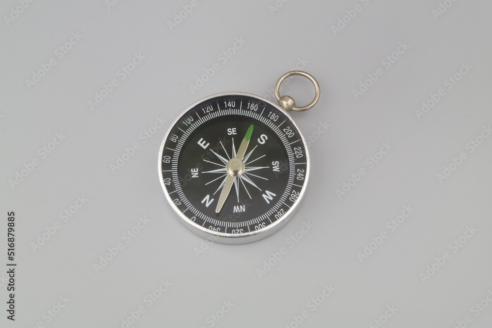 Compass on grey background. Find destination and navigation concept.