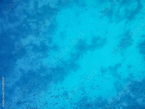 Natural water texture with air bubbles. Turquoise clean aqua background. View of the sea depth through the glass