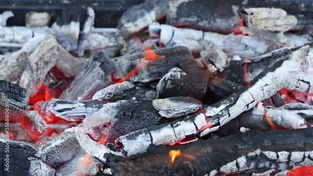 Fire is blazing on the BBQ grill over flaming hot charcoal for cooks the food Fire is blazing on the BBQ grill over flaming hot charcoal for cooks the food