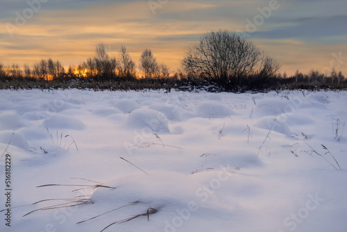 Snowy white field with a relief surface in the evening at sunset. Russia, Ural © olgaS