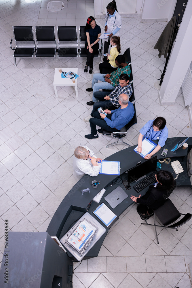 Top view of clinic reception with professional nurse and senior doctor ...