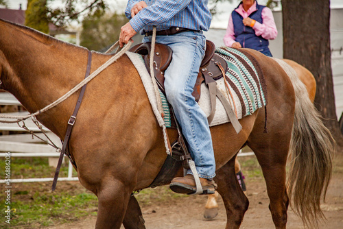 Close up of a man riding a stock horse at the showground photo