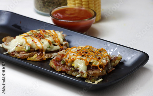 Mini Pizza or homemade baked potato pizza served with onion,tomato,corn,capsicum,cheese and mayonnise.