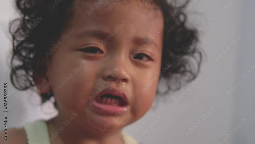 little asian baby girl with curly hair tantrum, crying loudly. slow motion video little asian baby girl with curly hair tantrum, crying loudly. slow motion video