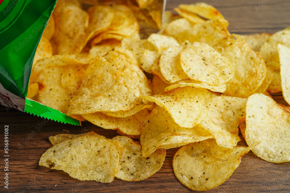 Potato chips in open bag, delicious BBQ seasoning spicy for crips, thin slice deep fried snack fast food in open bag.