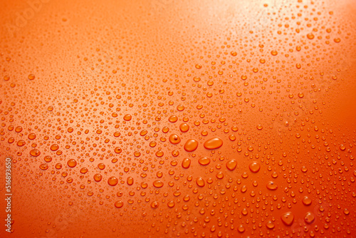 Spilled water on orange surface