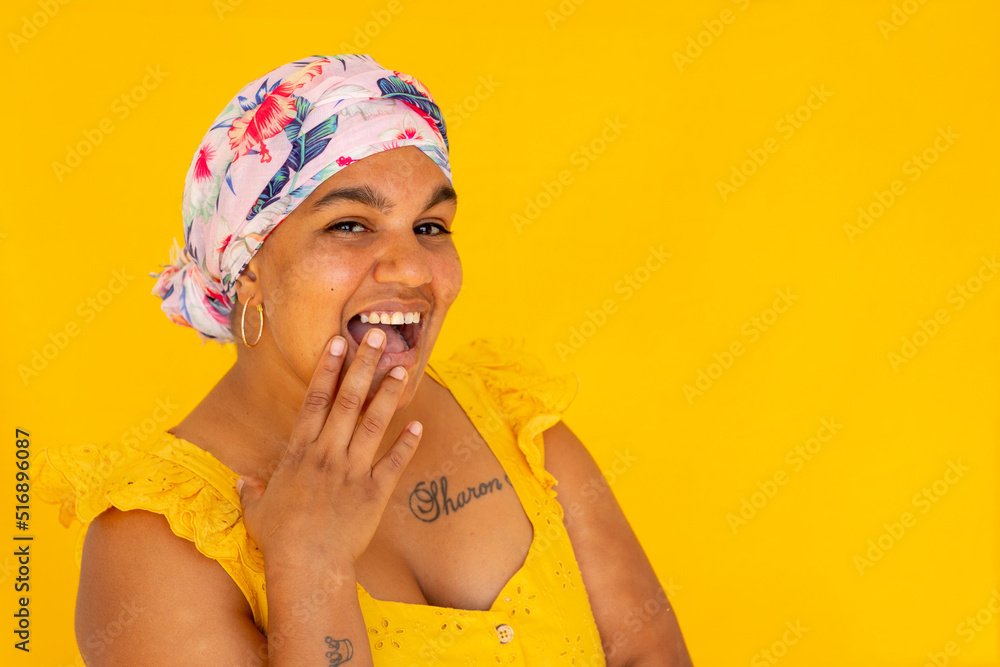 Indigenous Nyoongar woman wearing yellow against yellow backdrop Indigenous Nyoongar woman wearing yellow against yellow backdrop