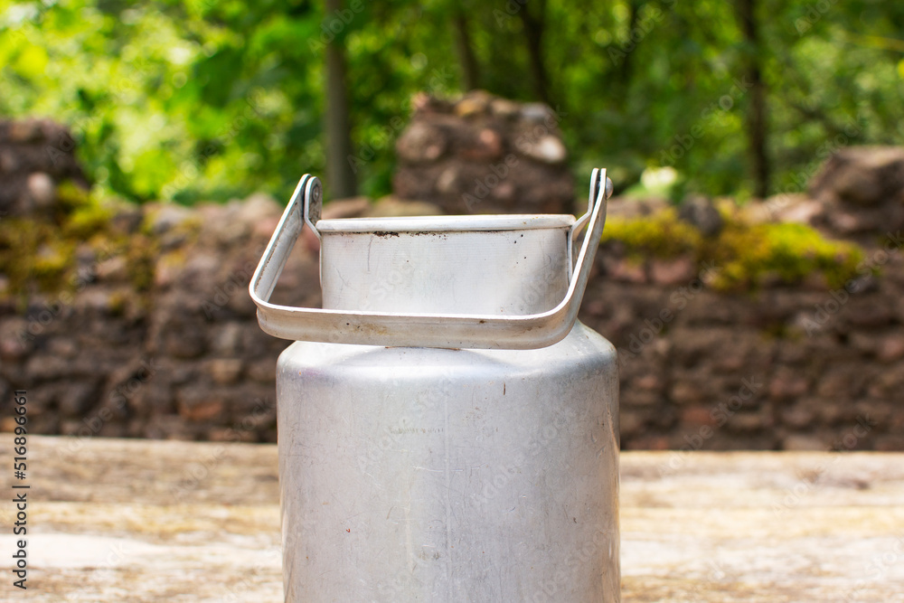 aluminum milk can on a background of greenery aluminum milk can on a background of greenery
