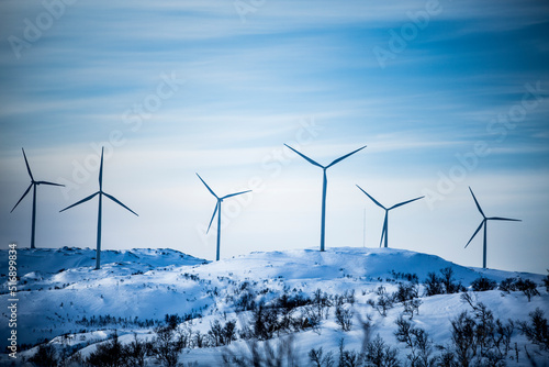 Wind turbine on snowy hills