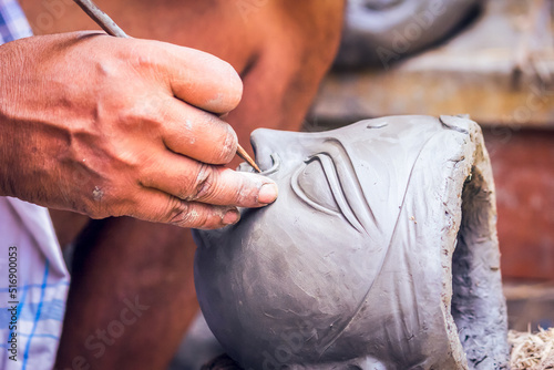 Creating clay head of goddess Durga in Kumartuli, Kolkata, India. The idols are made for the Hindu festival of Durga Puja also known as Dussehra
