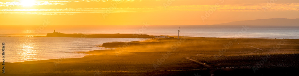 Lighthouse and coastline at sunset Lighthouse and coastline at sunset