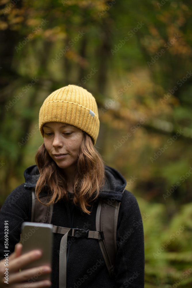 Young woman taking selfie during hike in Kolva Hallar Sweden