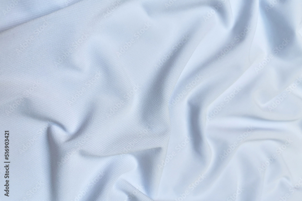 Blue crepe satin crumpled or wavy fabric texture background. Abstract linen cloth soft waves. Silk fabric. Smooth elegant luxury cloth texture. Concept for banner or advertisement. Blue crepe satin crumpled or wavy fabric texture background. Abstract linen cloth soft waves. Silk fabric. Smooth elegant luxury cloth texture. Concept for banner or advertisement.