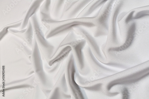 White supplex crumpled or wavy fabric texture background. Abstract linen cloth soft waves. Silk fabric. Smooth elegant luxury cloth texture. Concept for banner or advertisement.