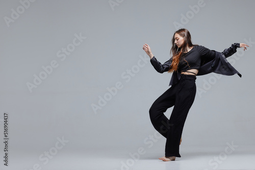 Fotografiet Beautiful young modern dancer or fitness dancer on a white isolated background
