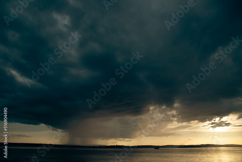 Heavy dark fast moving thunderstorm clouds over lake Constance  Germany
