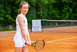 Female tennis player holding the racket while waiting for serve.