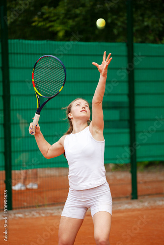 Young female tennis player serving. © Dmytro Panchenko