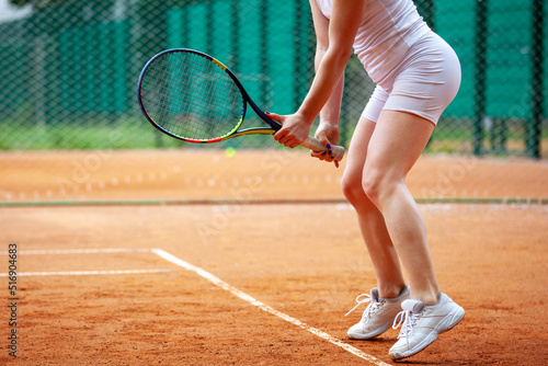 Female tennis player holding the racket. © Dmytro Panchenko