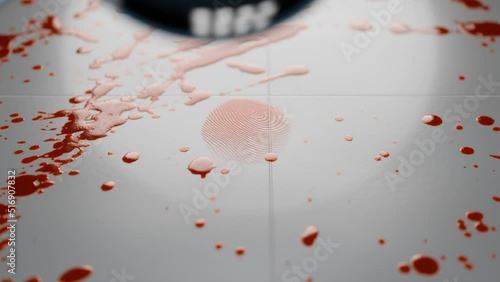 Fresh blood splatter and fingerprint being investigated under a magnifying glass photo