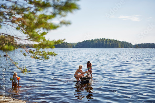 Family playing in lake photo