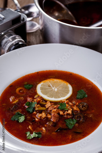 Soup with parsley, lemon, olives and meat