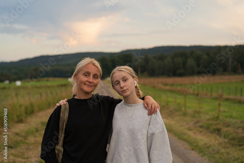 Portrait of mother and daughter on rural road photo