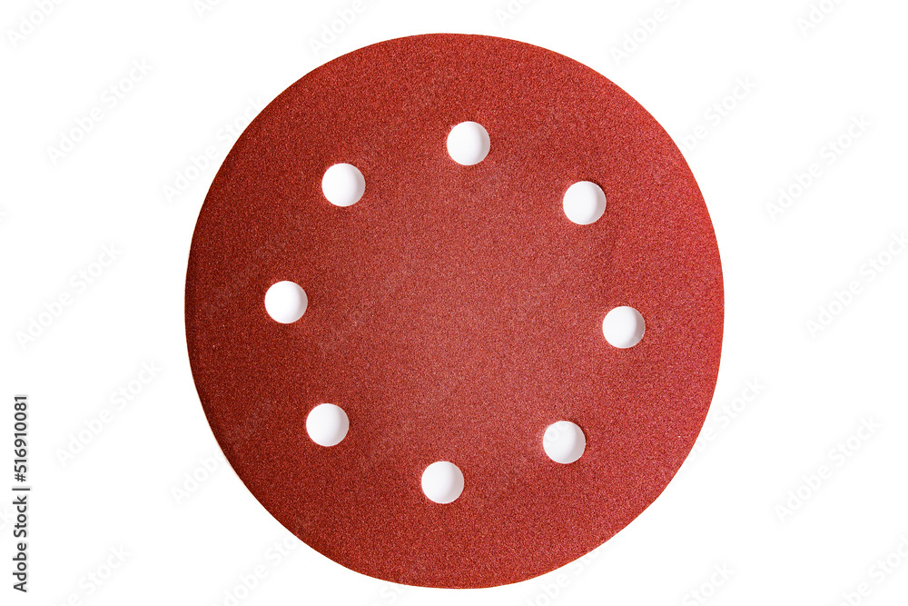 Fototapeta premium Round sandpaper discs with holes for a vacuum grinder isolated on a white background.