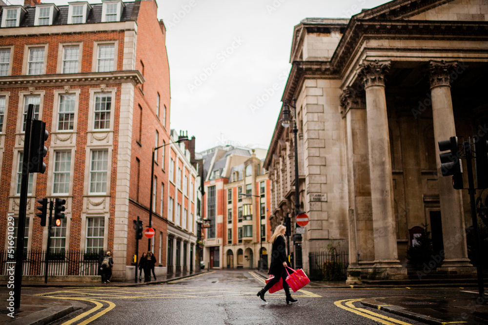 Young woman walking with shopping bags on street Young woman walking with shopping bags on street