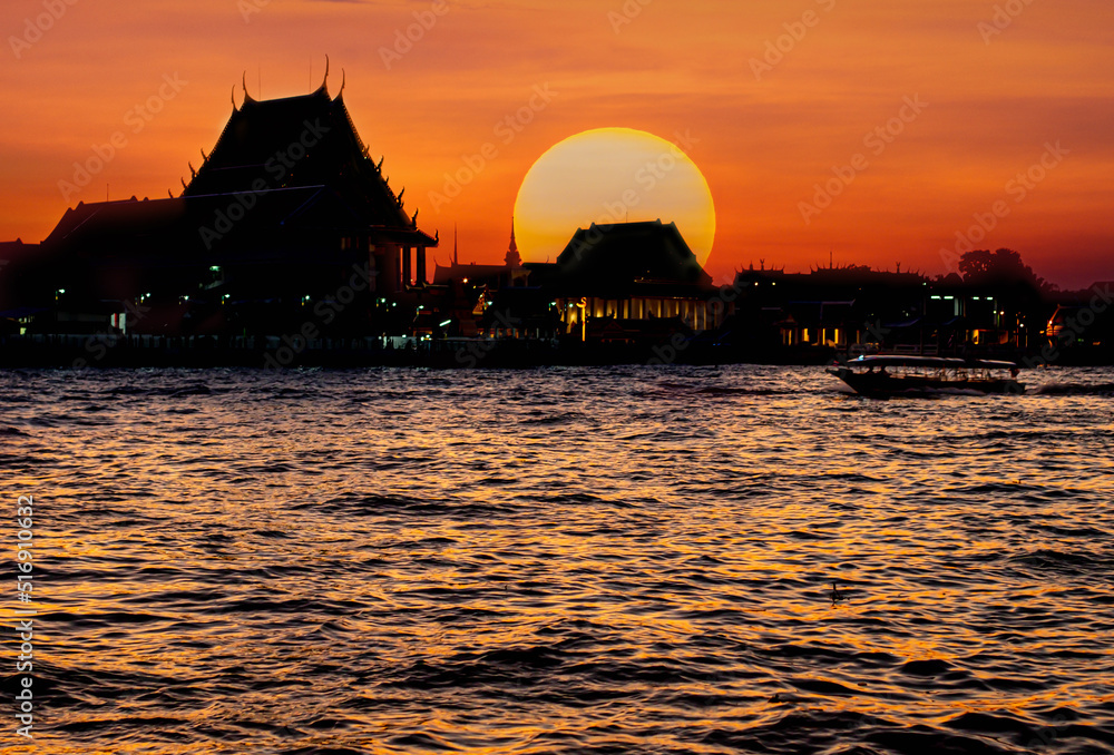 Silhouette temple in Bangkok with river view at sunset sundown moment