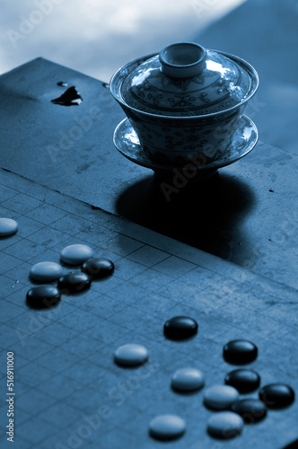 Traditional Chinese Tea Pot Set and stones on a Go board photo