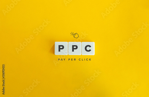 PPC (Pay Per Click) Banner and Concept. Text on Block Letter Tiles on Yellow Orange Background. Minimal Aesthetics.Letter Tiles on Yellow Background. Minimal Aesthetics. photo