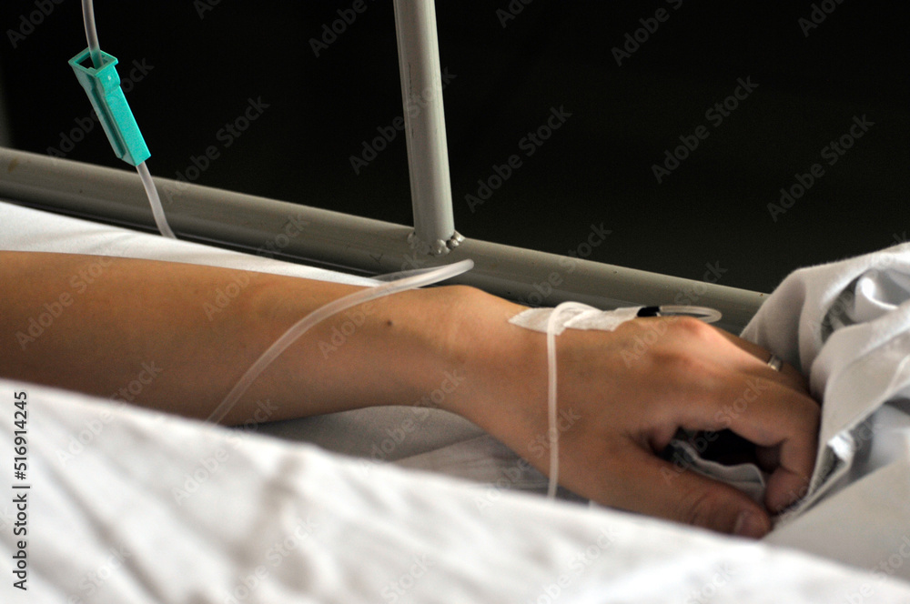 Fototapeta premium Asian women patient is on drip receiving saline solution