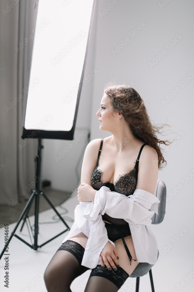 young sexy woman in lingerie and stockings posing in studio Photos | Adobe  Stock