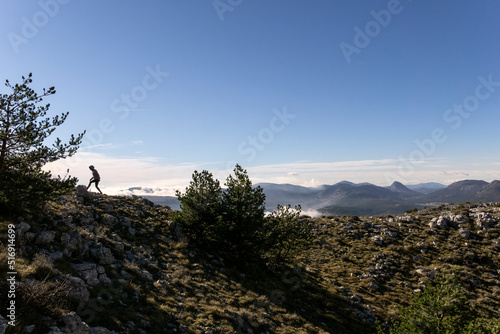 Silhouette of woman hiking by trees in Cote d'Azur France photo