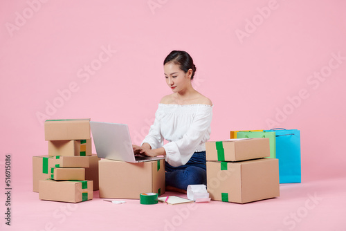 woman working at home office packaging on background