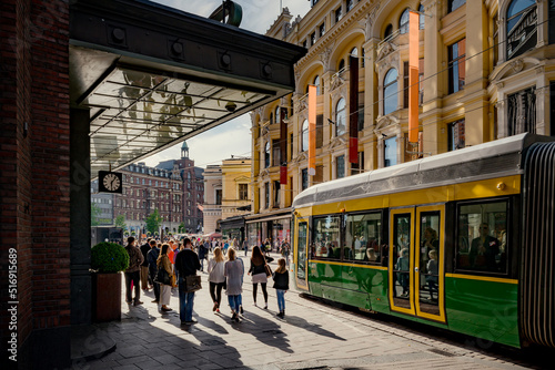 Pedestrians and tram on city street in Helsinki Finland photo