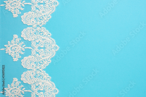 White laces on blue background isolated vertically. Copy space