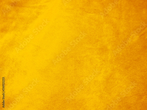 Yellow old velvet fabric texture used as background. Empty golden fabric background of soft and smooth textile material. There is space for text..