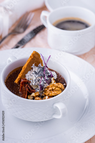 Dessert in a cup with walnuts, pastries, cream and poppy seeds