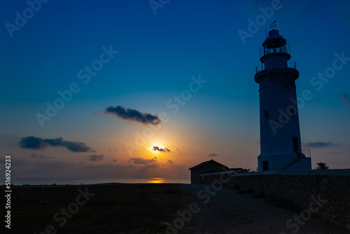 Beautiful sunset at the lighthouse of Kato Paphos coastline.
