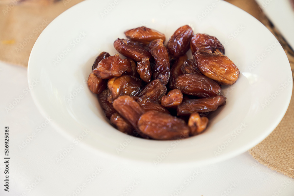 a white dish with dates