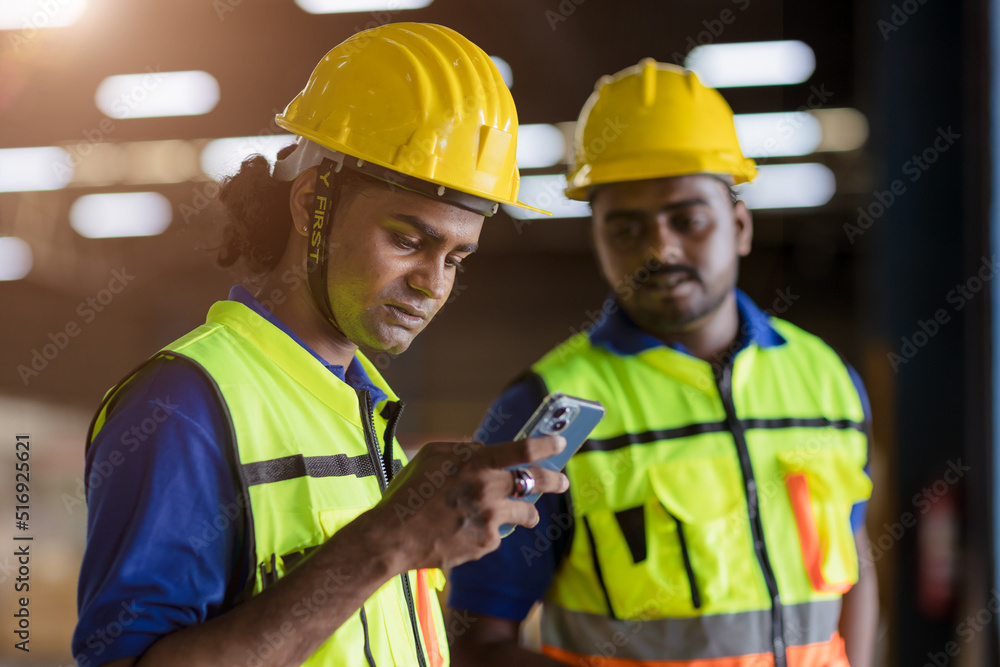 factory engineer worker reading bad news lay off notify at smartphone serious worry expression factory engineer worker reading bad news lay off notify at smartphone serious worry expression