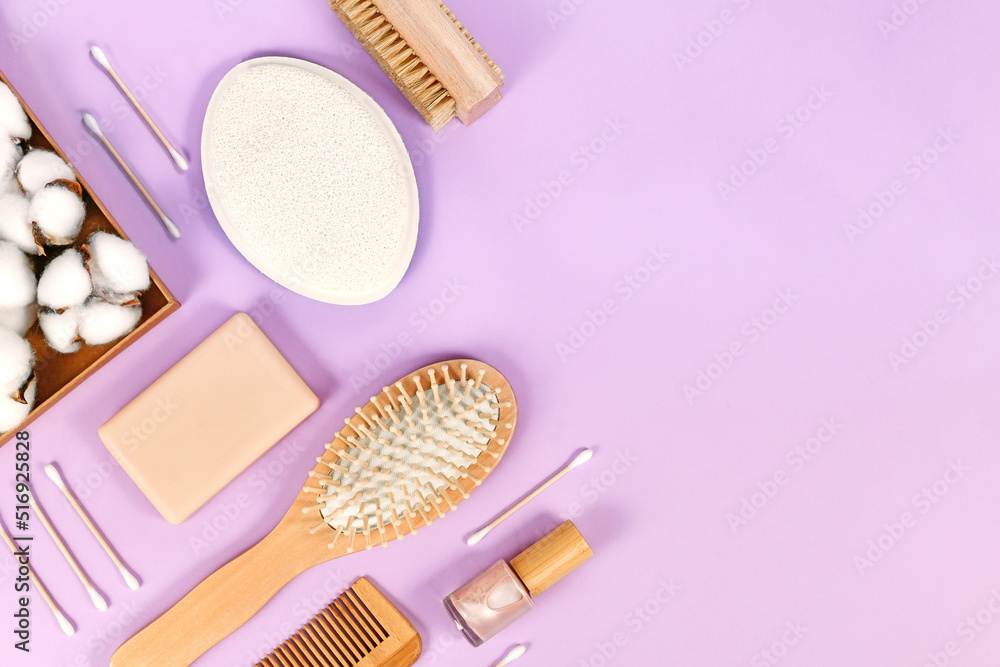 Eco friendly wooden beauty and hygiene products like comb and soap arranged on violet background Eco friendly wooden beauty and hygiene products like comb and soap arranged on violet background