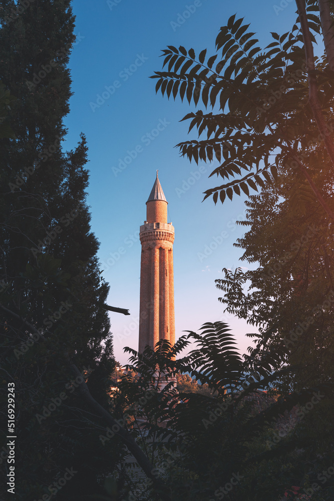 Obraz premium Yivli or flute minaret mosque is a religious symbol and travel landmark of Antalya resort town in Turkey. Attractions and destinations in Kaleice old town