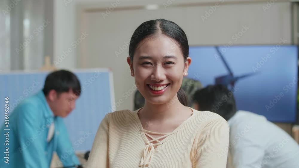 Close Up Of Smiling Asian Woman Engineer Crossing Her Arms To Camera While Her Colleagues Are Discussing About The Wind Turbine At The Office
Close Up Of Smiling Asian Woman Engineer Crossing Her Arms To Camera While Her Colleagues Are Discussing About The Wind Turbine At The Office