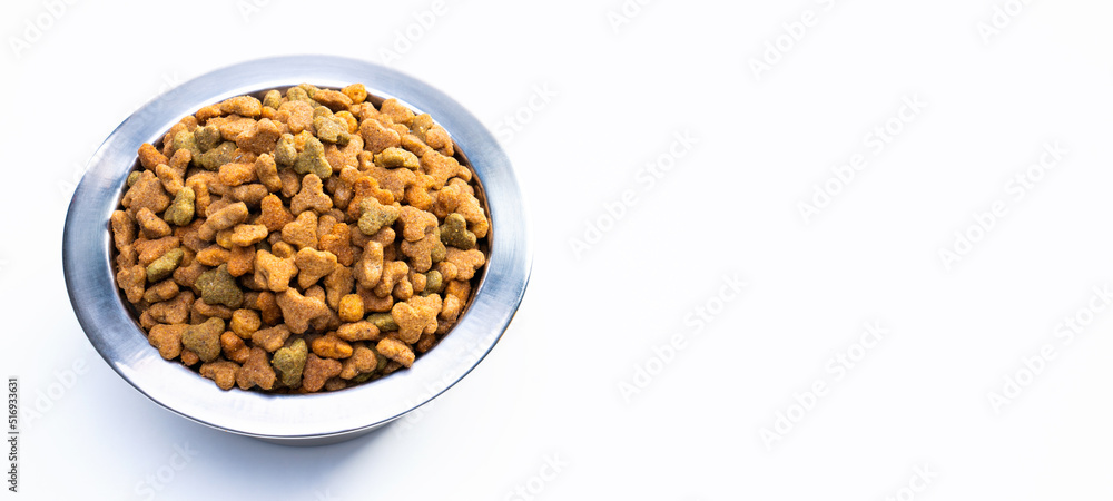 Round metal bowl for pets with dry food. Isolated on white background. View from above. Full plate with a slide Round metal bowl for pets with dry food. Isolated on white background. View from above. Full plate with a slide